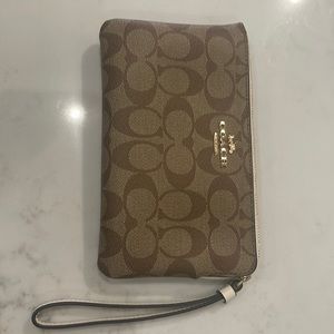 Coach Signature coated canvas & smooth leather. Zip closure. Wrist strap. NEW